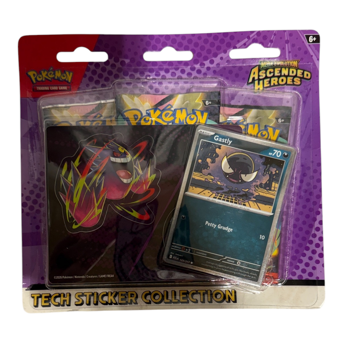 Actual sealed Pokémon TCG Ascended Heroes Gastly Tech Sticker Collection, purple packaging with visible handling wear