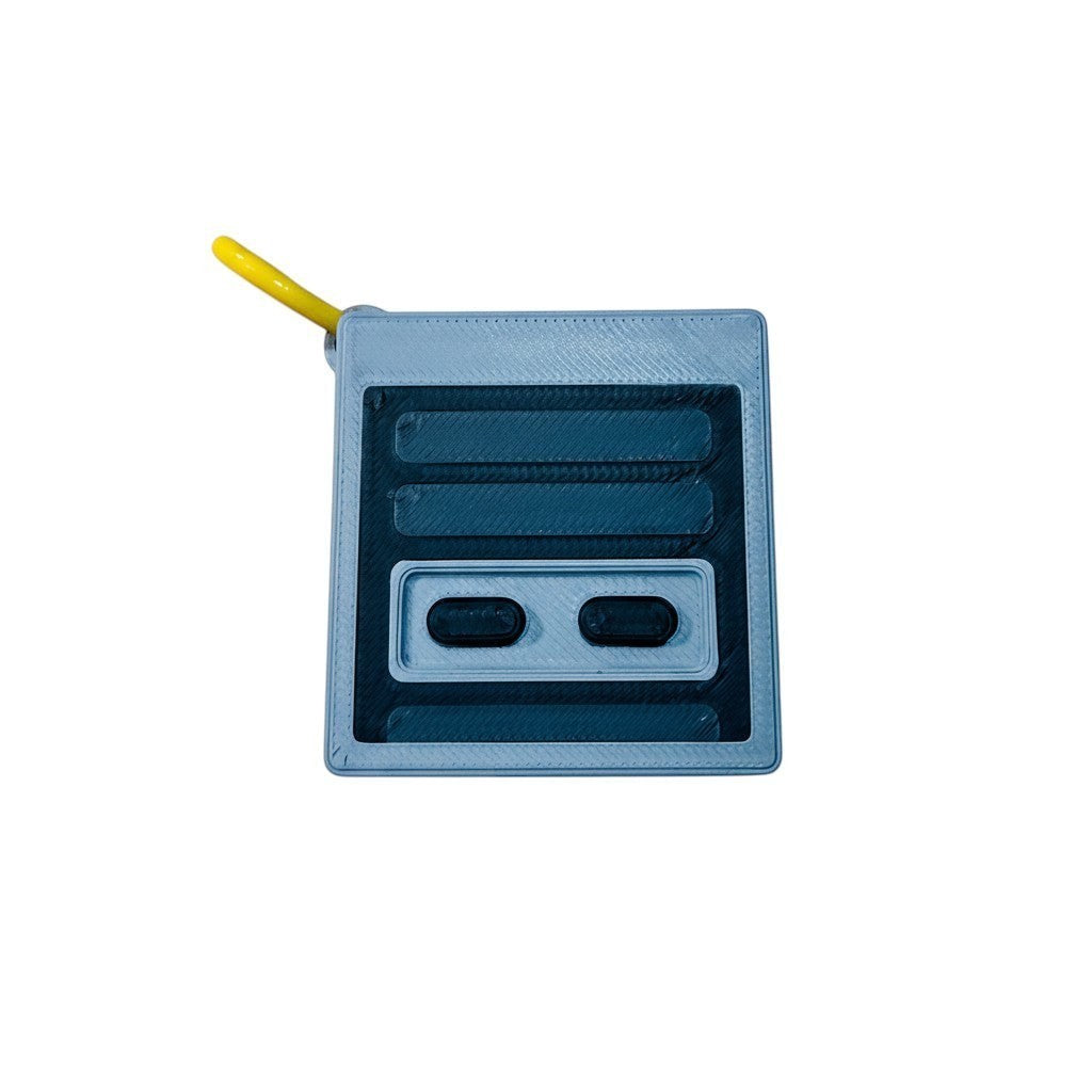 Wacky McLovin Prints NES-inspired controller keychain accessory, grey and black 3D printed with yellow loop.