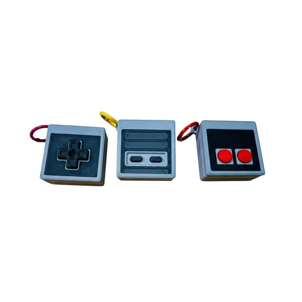 Wacky McLovin Prints NES-inspired controller keychain accessory with D-pad, buttons, and console details. Grey 3D-printed.